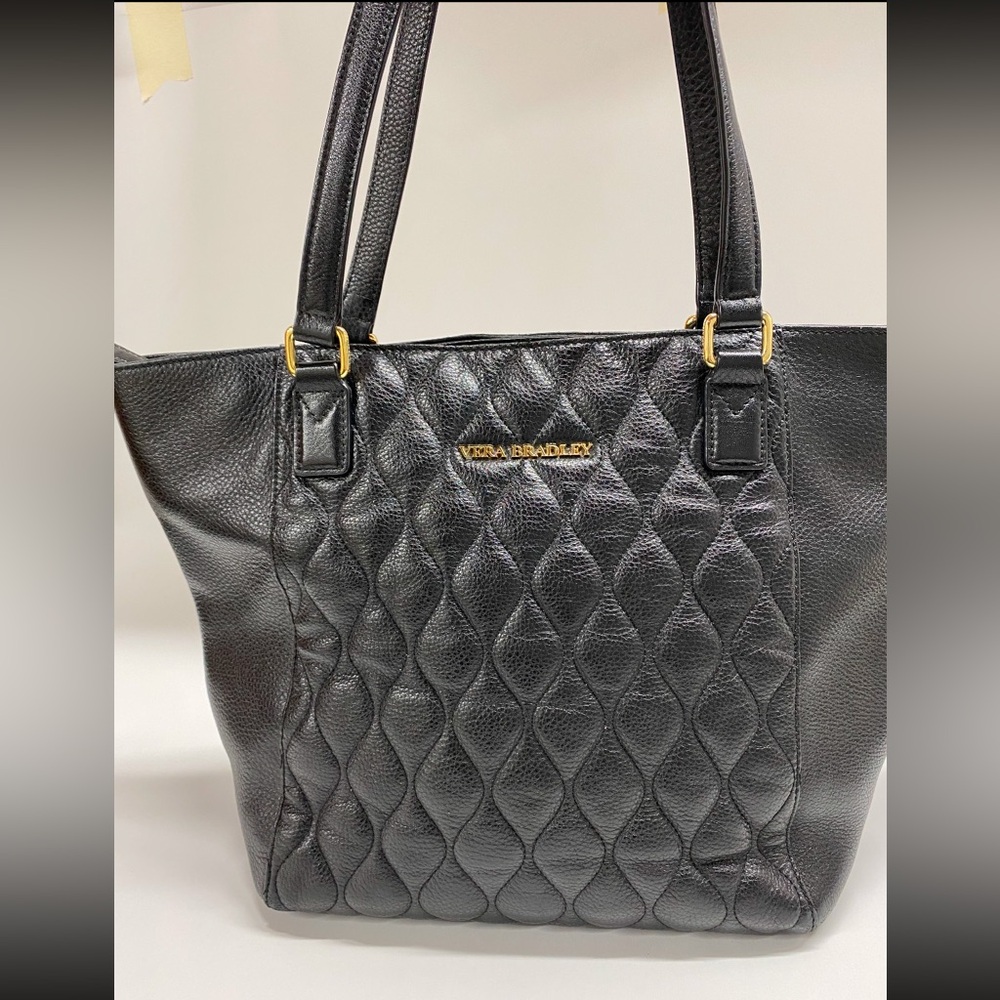 Vera Bradley is a black quilted leather tote.